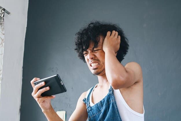 A person looking frustrated at a smartphone with a 