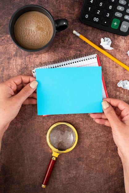 A person's hand holding a magnifying glass over small text on a financial statement, highlighting the importance of reading fine print for reward policies.