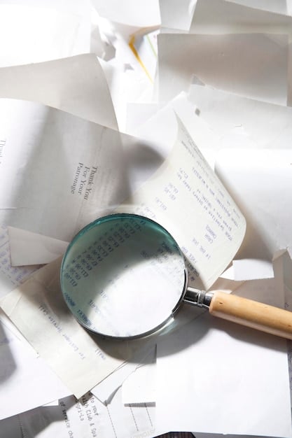 A magnifying glass held over a stack of documents with financial terms, symbolizing the careful scrutiny of terms and conditions.