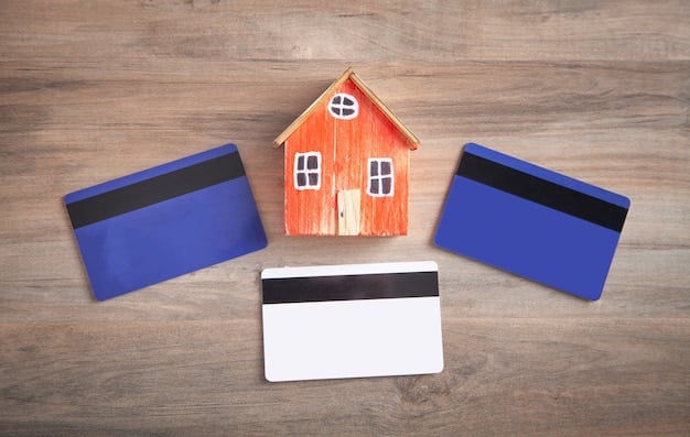 A stack of credit cards featuring various bank logos next to a miniature house model, atop a budgeting notebook and pen, illustrating financial tools for home improvement.