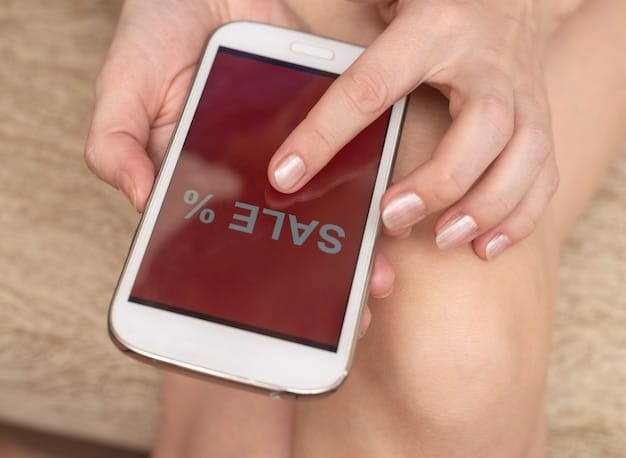 A mobile phone screen displaying a push notification from a price comparison app, announcing a significant price drop on a desired product, overlaid on a blurred image of online shopping.